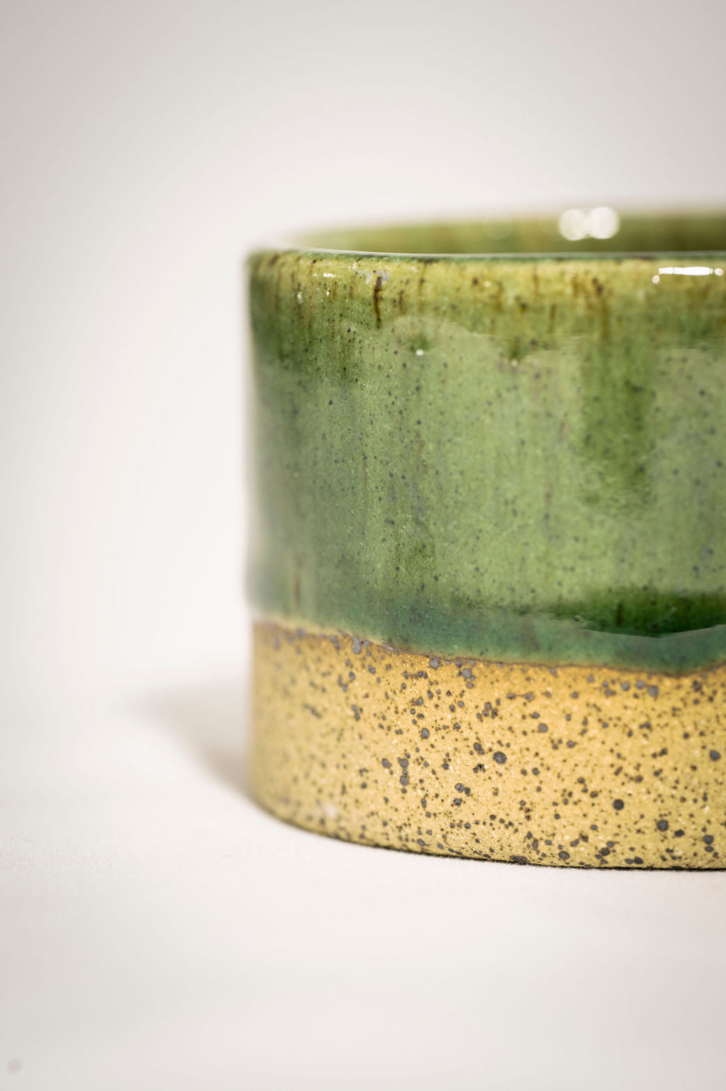 Detail and close up shot of speckled green ceramic ramekin.