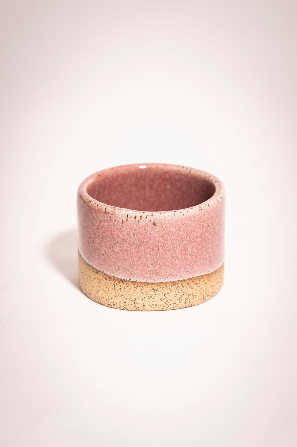 Speckled pink ceramic ramekin.