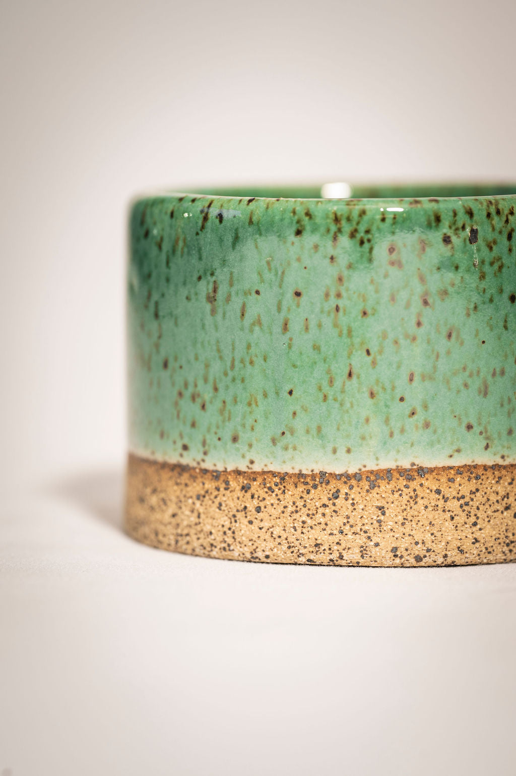 Detail and close up shot of speckled turqoise ceramic ramekin.