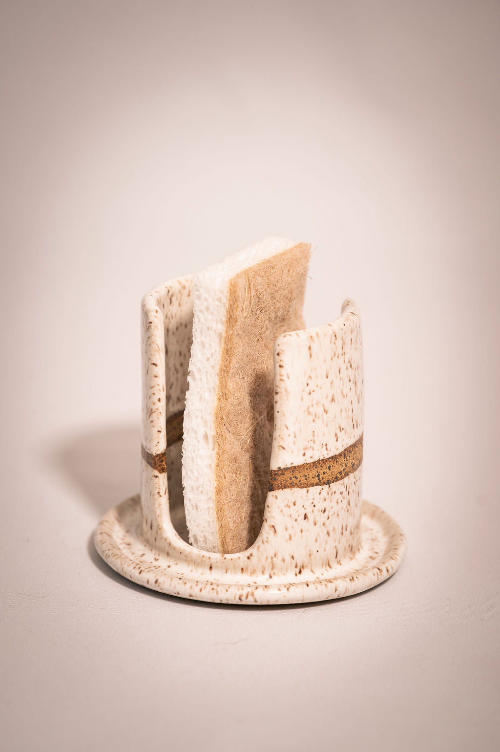 White speckled ceramic sponge holder.