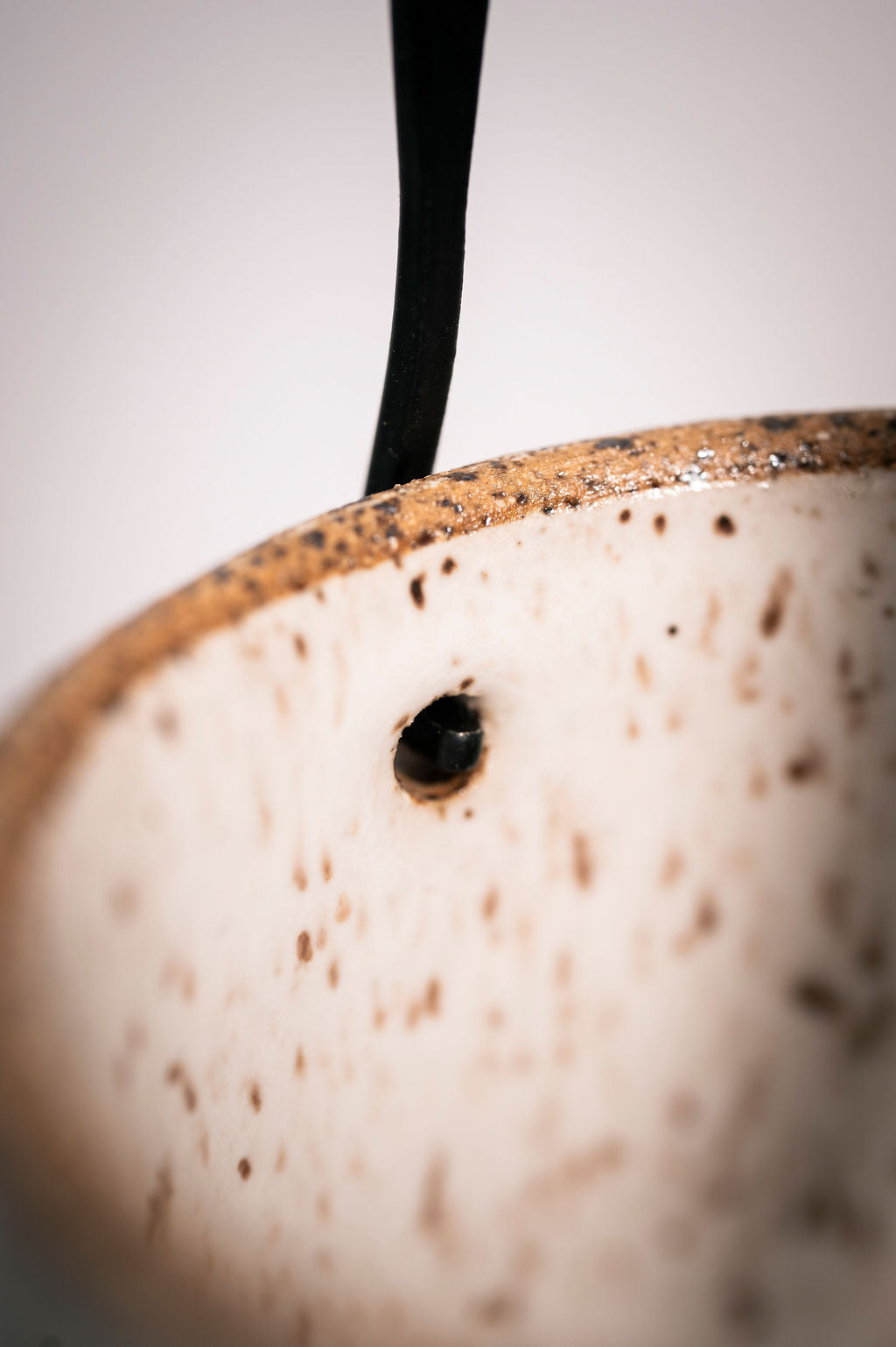 Close up of how the metal handle is securely attached to the ceramic lantern.