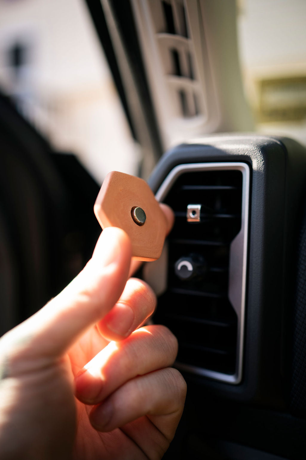 Showing back of the clay essential oil diffuser where there is a magnet to attach it to a clip for your car vent. 